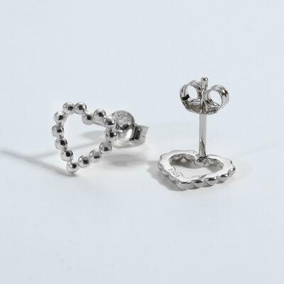 a pair of heart shaped studs on a white background