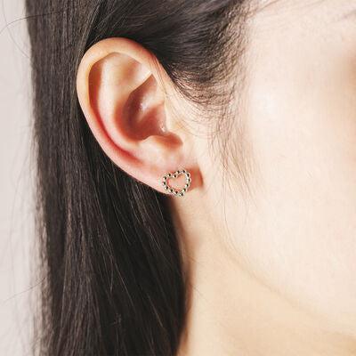 a close up of a person wearing a pair of earrings