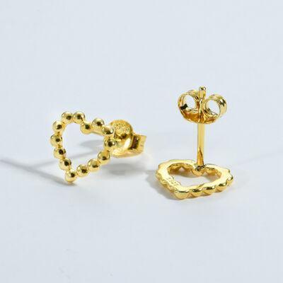 a pair of gold earrings on a white background