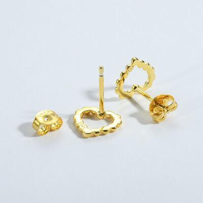 a pair of gold earrings on a white background