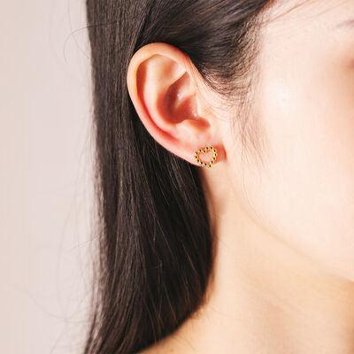 a close up of a person wearing a pair of earrings