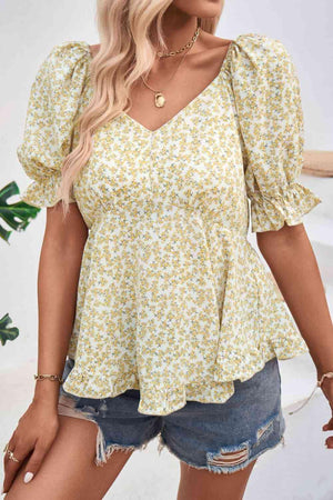 a woman wearing a yellow floral top