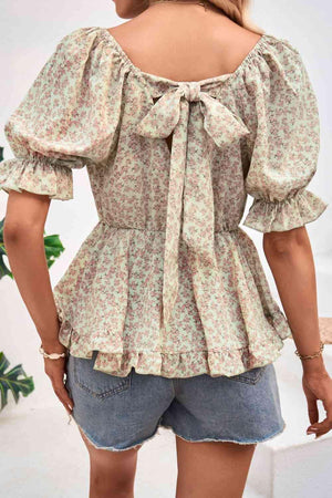 the back of a woman wearing a floral blouse