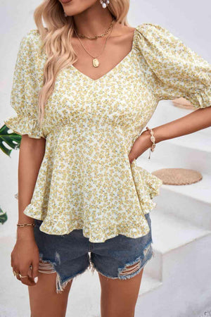 a woman wearing a yellow floral top