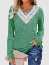 a woman wearing a green sweater with white trim