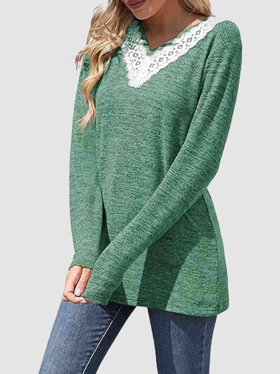 a woman wearing a green sweater and jeans