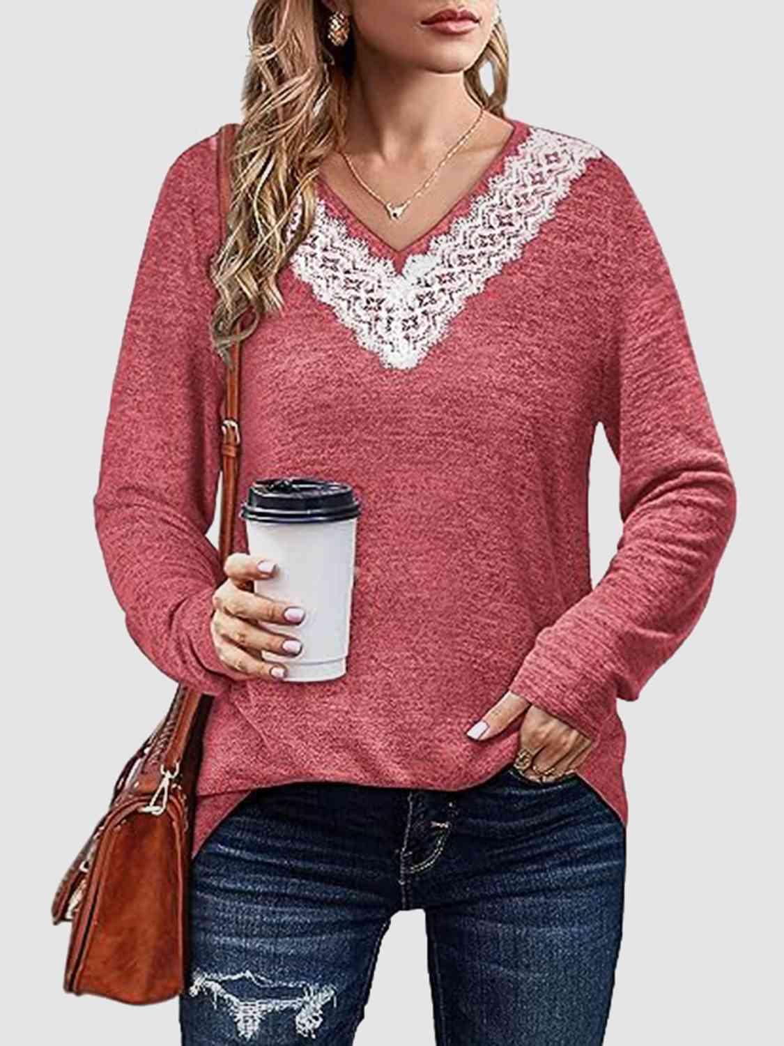 a woman holding a cup of coffee wearing a red sweater