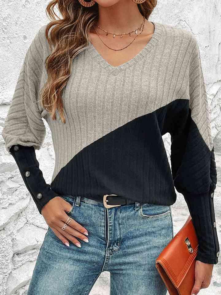 a woman wearing a sweater and jeans