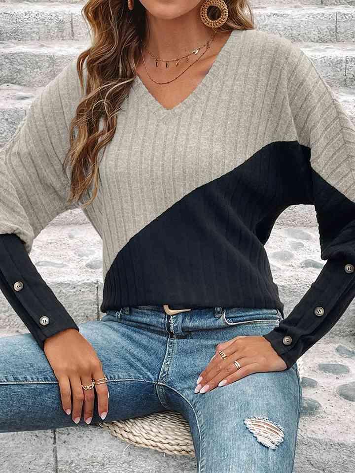 a woman wearing a sweater and jeans posing for a picture