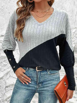 a woman wearing a sweater and jeans