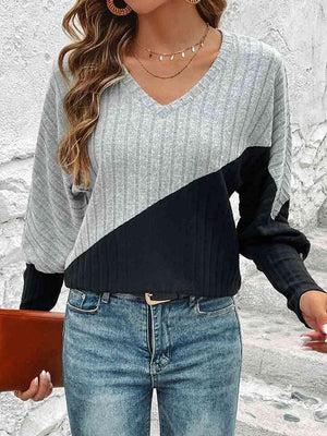 a woman wearing a sweater and jeans