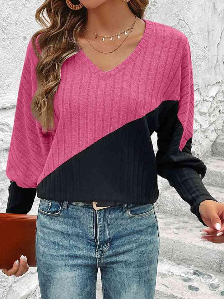 a woman wearing a pink and black sweater