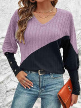 a woman wearing a purple and black sweater