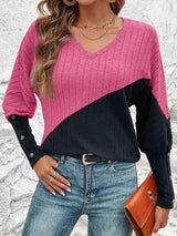 a woman wearing a pink and black sweater