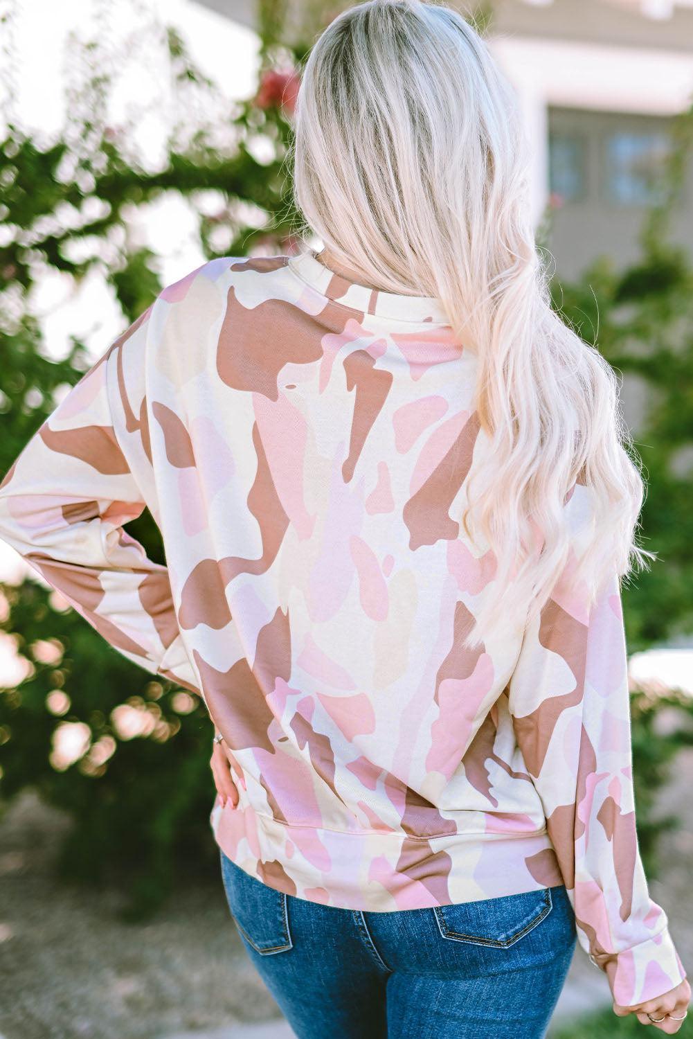 a woman wearing a pink camo top