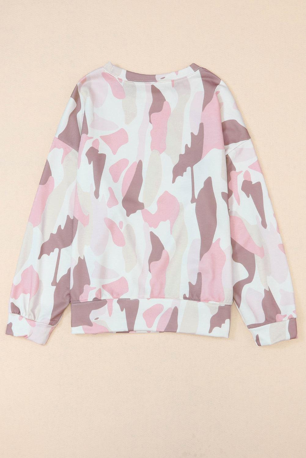 a pink and white camo sweatshirt on a beige background