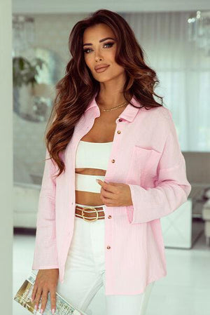 a woman in white pants and a pink jacket