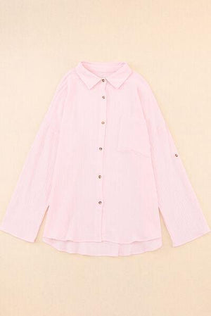 a pink shirt with buttons on the collar