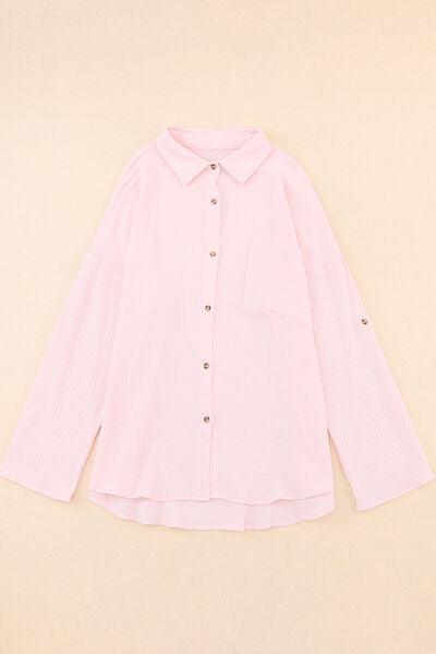 a pink shirt with buttons on the collar