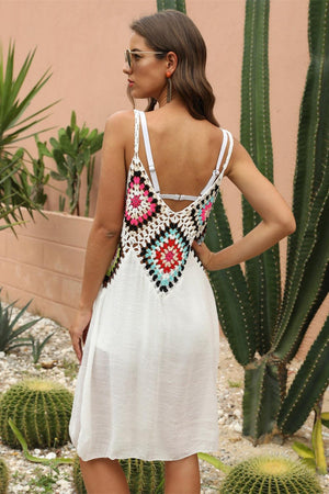 a woman standing in front of a cactus