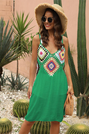 a woman wearing a green dress and a straw hat