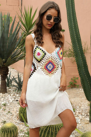 a woman standing in front of a cactus