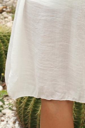 a close up of a person's legs with a cactus in the background