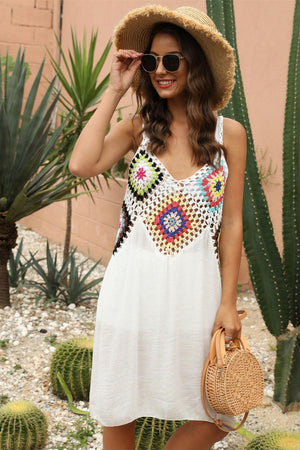 a woman in a white dress and straw hat