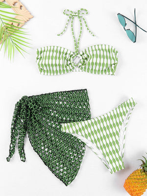 a green and white bikini with a pineapple next to it