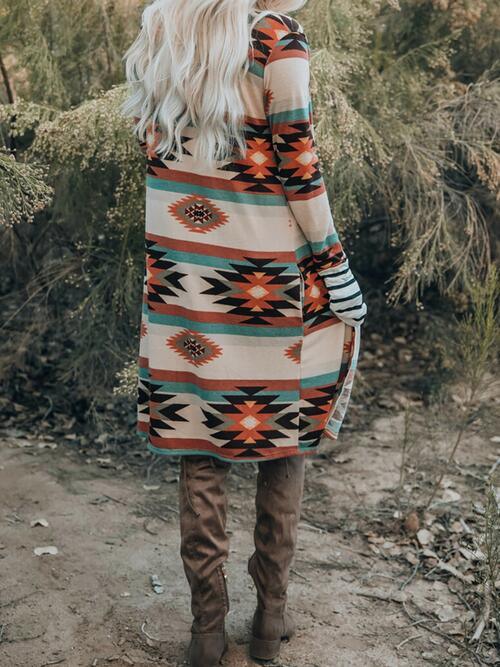 a woman standing on a dirt road wearing a colorful dress