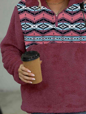 a woman holding a cup of coffee and a cell phone