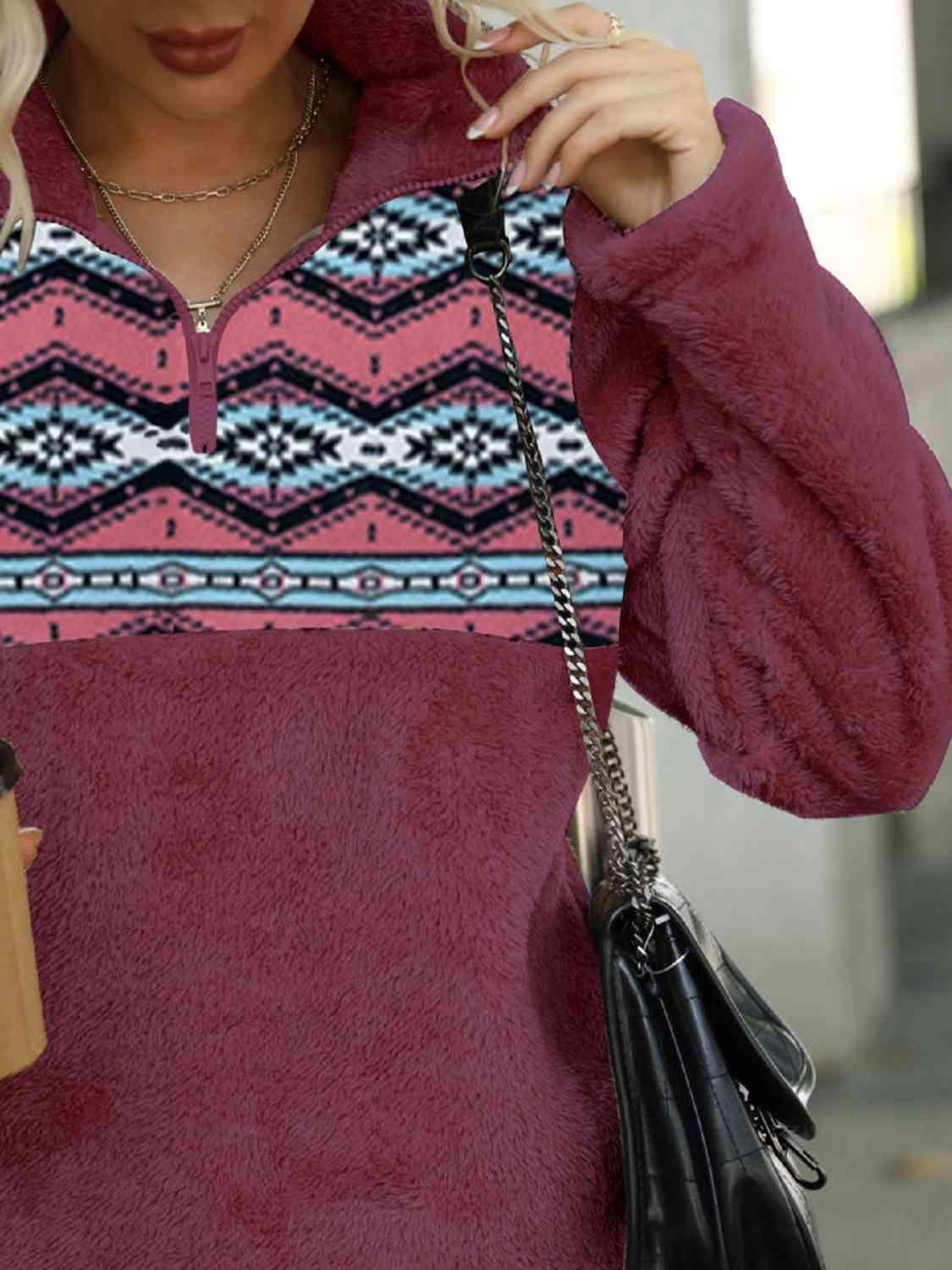 a woman with blonde hair wearing a red sweater