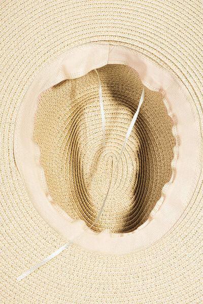 a straw hat with a white string attached to it