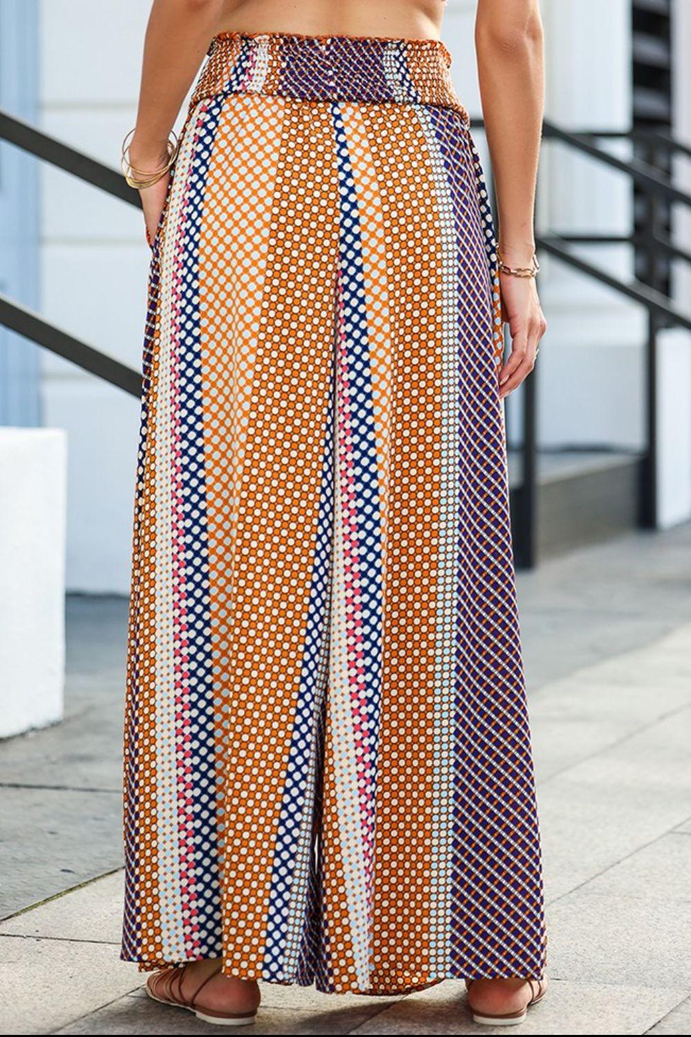 a woman standing on a sidewalk wearing a skirt