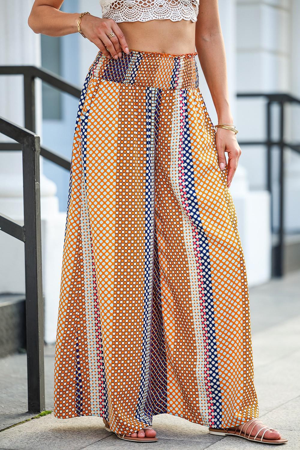 a woman standing on a sidewalk wearing a skirt