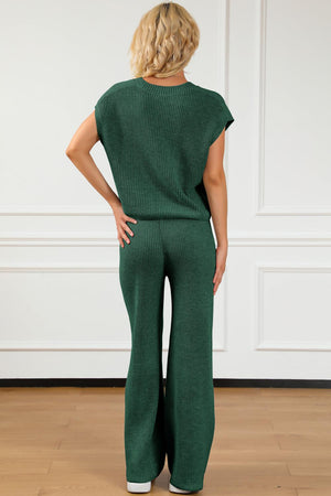 a woman in a green jumpsuit with her hands on her hips