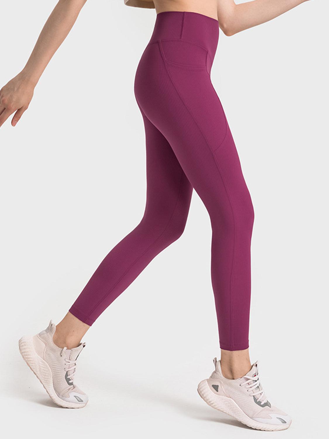 a woman in a sports bra top and purple leggings