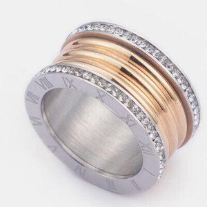 a gold and silver ring with diamonds on it