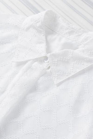 a close up of a white shirt on a table