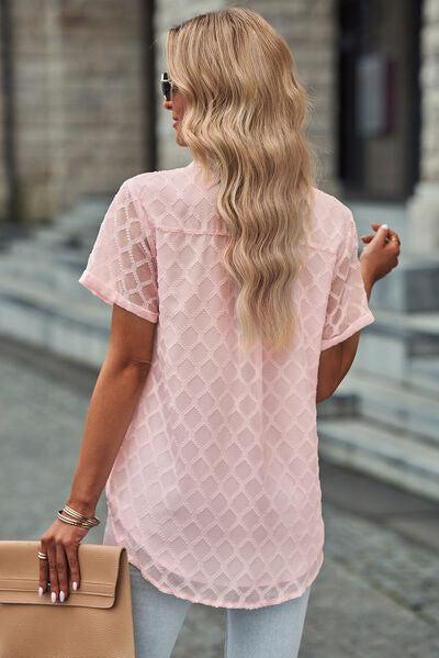 a woman with long blonde hair wearing a pink top