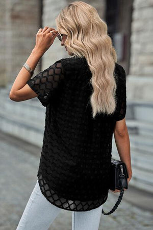 a woman walking down a street wearing a black top