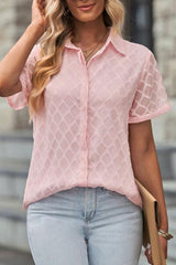 a woman wearing a pink shirt and jeans