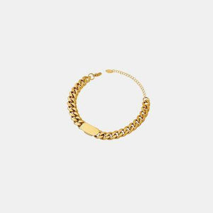 a gold chain bracelet on a white background