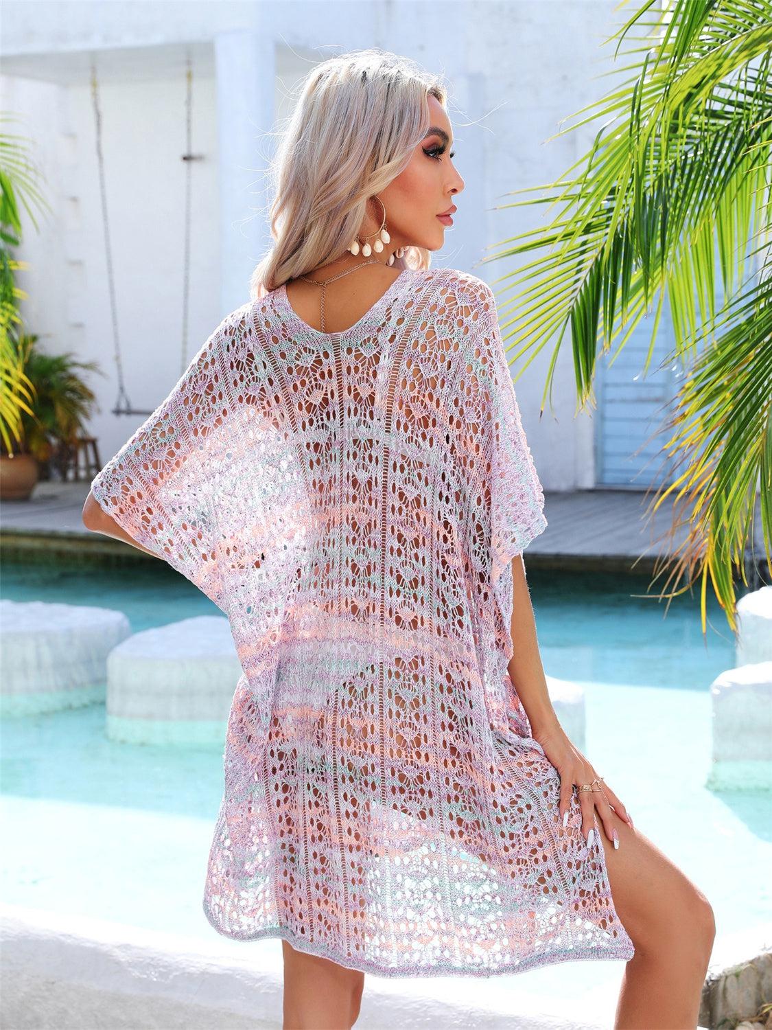 a woman standing next to a pool wearing a pink crochet cover up