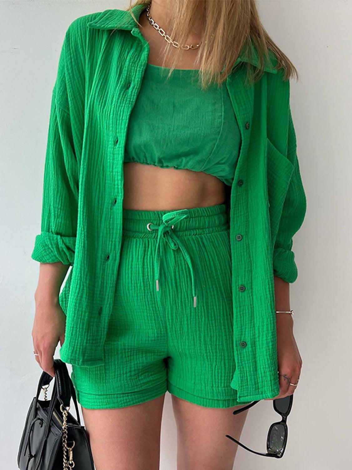 a woman in a green shirt and shorts
