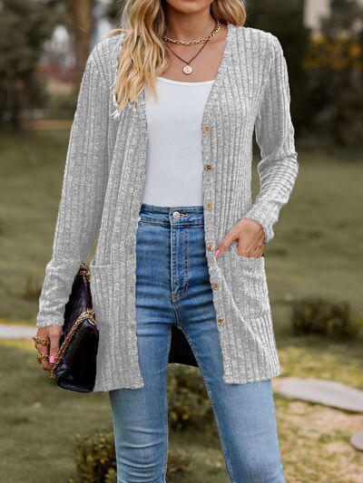 a woman wearing a cardigan sweater and jeans