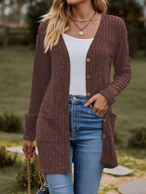 a woman wearing a brown cardigan sweater and jeans