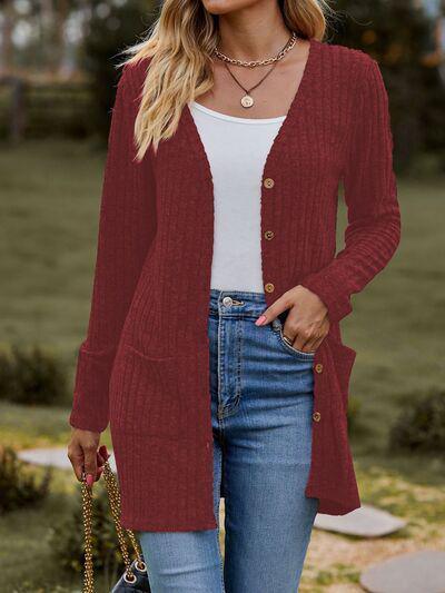 a woman wearing a red cardigan sweater and jeans