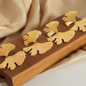 a close up of a piece of wood with gold flowers on it