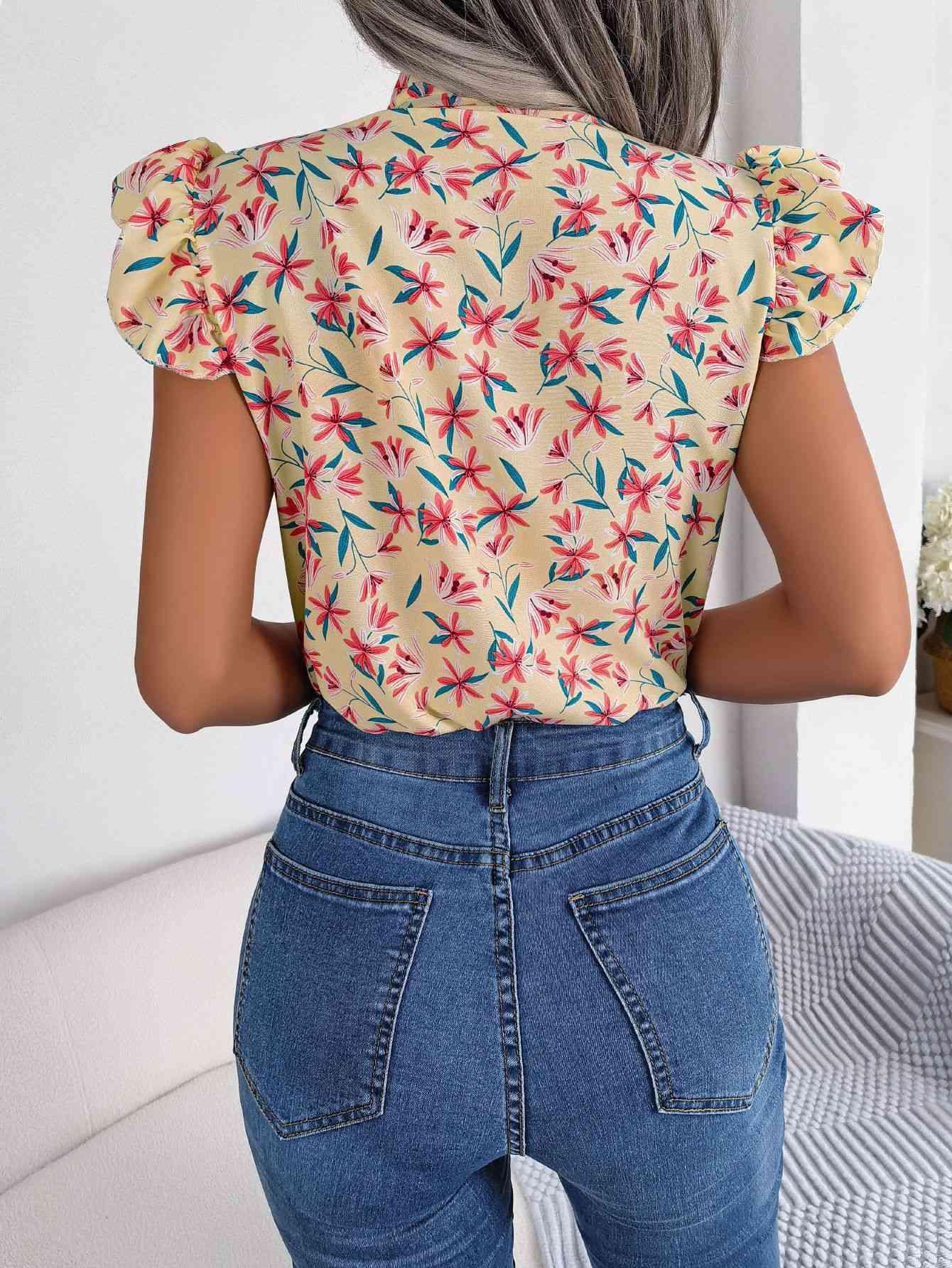 the back of a woman wearing a floral top